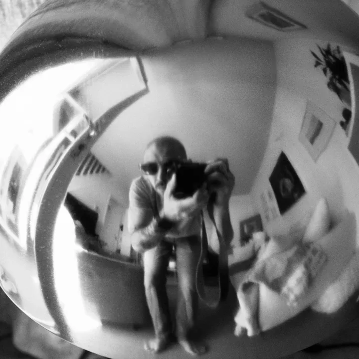 Self-portrait reflected in a chrome sphere