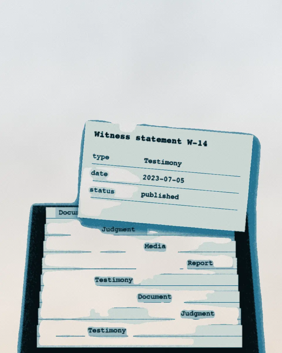 A card catalogue drawer pulled out, with tabbed index cards standing in it and one card lifted. The print is in black and a blue ink.