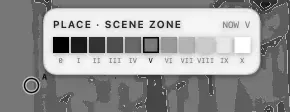 A close view of the wedge: eleven grey swatches from black to white, the sixth outlined, NOW V above it, and the pin just left of it.