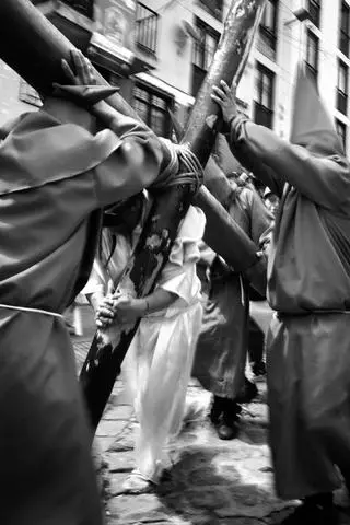Quito, 2026. A penitent carrying a cross on Good Friday.