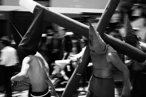 Quito, 2026. Cucuruchos and crosses in the Good Friday procession.